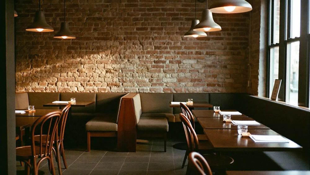 A wide view of the cafe's booth seating and brick walls